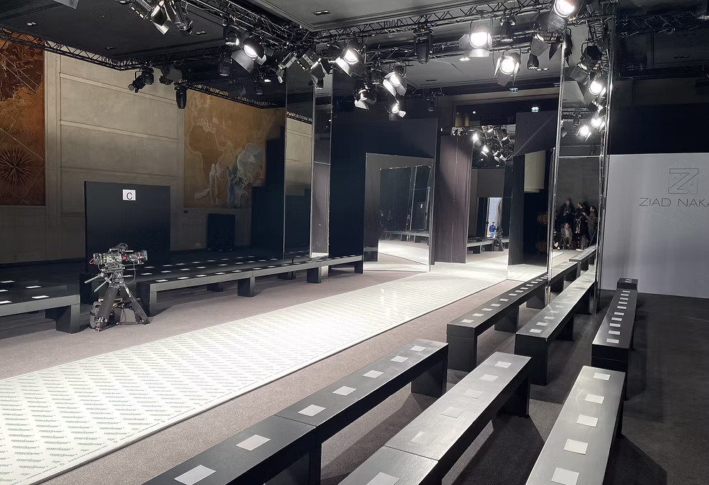 Runway with mirrored panels, seating and overhead lighting